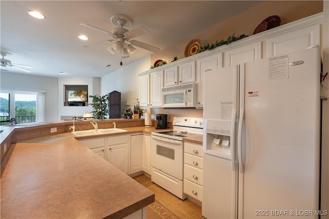 440 Cedar Heights Dr Unit 1C, Camdenton, MO 65020 - kitchen with white appliances, a ceiling fan, a peninsula, recessed lighting, and white cabinetry
