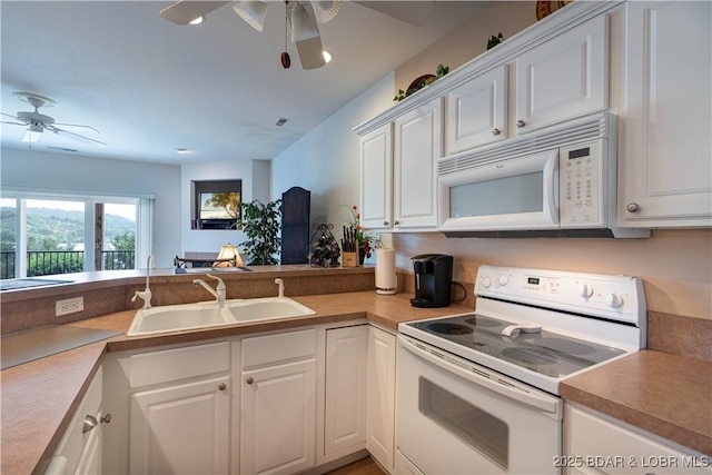 440 Cedar Heights Dr Unit 1C, Camdenton, MO 65020 - kitchen featuring white appliances, a ceiling fan, white cabinets, light countertops, and a peninsula