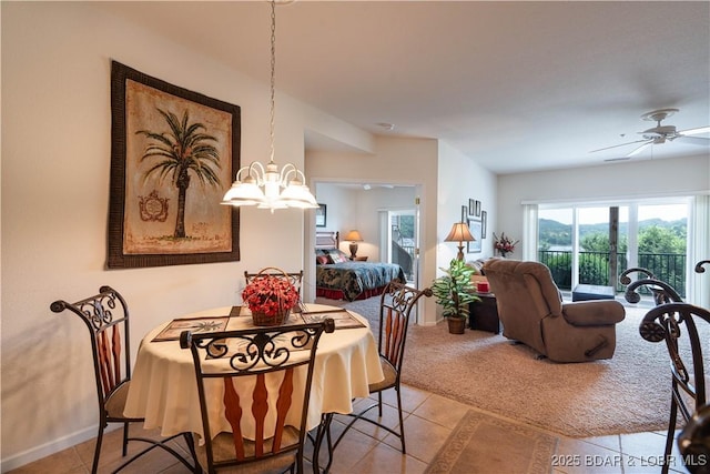440 Cedar Heights Dr Unit 1C, Camdenton, MO 65020 - dining area with a chandelier, light tile patterned floors, ceiling fan, and light colored carpet