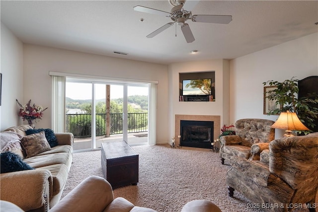 440 Cedar Heights Dr Unit 1C, Camdenton, MO 65020 - living area with carpet, a tile fireplace, and a ceiling fan