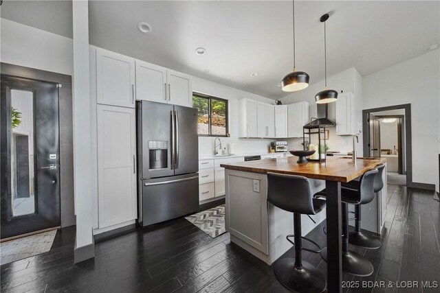 626 Eagle Dr, Four Seasons, MO 65049 - kitchen featuring stainless steel refrigerator with ice dispenser, butcher block countertops, a center island with sink, white cabinets, and dark wood-type flooring