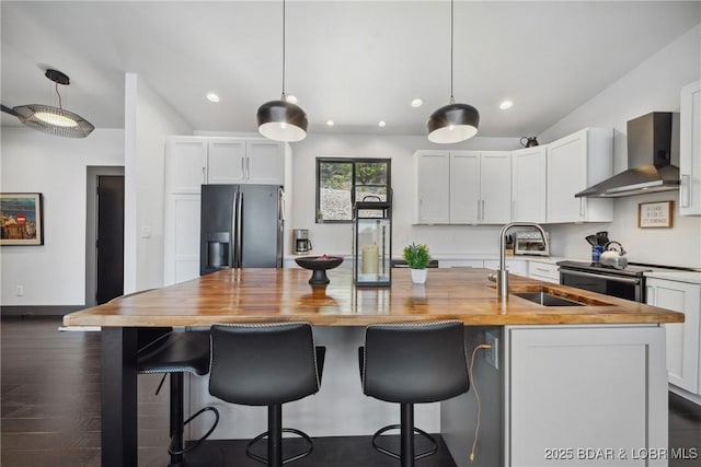 626 Eagle Dr, Four Seasons, MO 65049 - kitchen featuring appliances with stainless steel finishes, wall chimney exhaust hood, butcher block counters, white cabinets, and recessed lighting