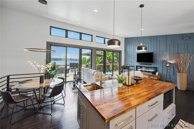 626 Eagle Dr, Four Seasons, MO 65049 - kitchen featuring wood counters, black microwave, dark wood-style floors, healthy amount of natural light, and recessed lighting