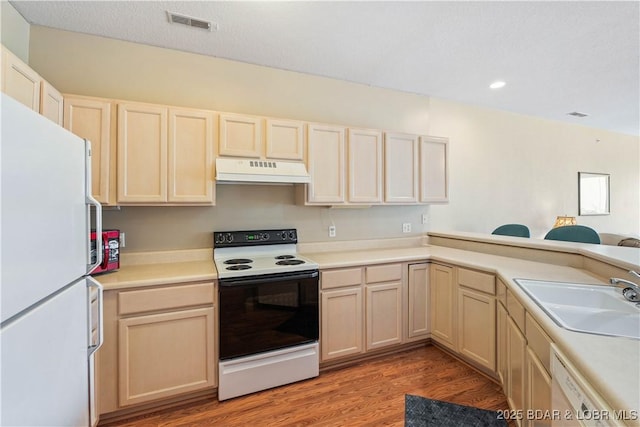 34 Bristol Bay Dr Unit 1C, Lake Ozark, MO 65049 - kitchen featuring white appliances, extractor fan, light wood finished floors, light countertops, and recessed lighting