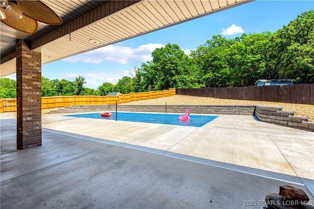 82 Fawn Meadows Dr, Linn Creek, MO 65052 - fenced backyard featuring view of scattered trees, a patio area, and a ceiling fan