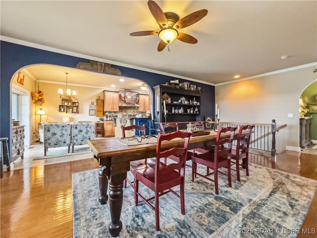172 Highland Pkwy, Camdenton, MO 65020 - dining area featuring arched walkways, ornamental molding, ceiling fan, wood finished floors, and recessed lighting
