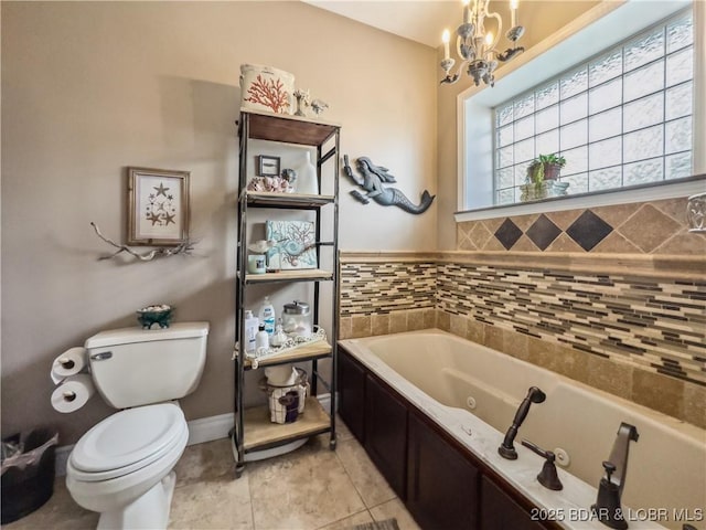172 Highland Pkwy, Camdenton, MO 65020 - bathroom with a tub with jets, tile patterned flooring, and a chandelier