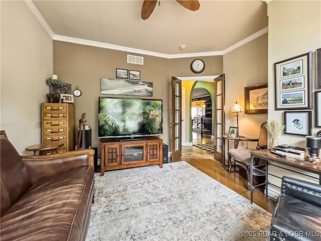 172 Highland Pkwy, Camdenton, MO 65020 - living room with arched walkways, ornamental molding, a ceiling fan, and wood finished floors