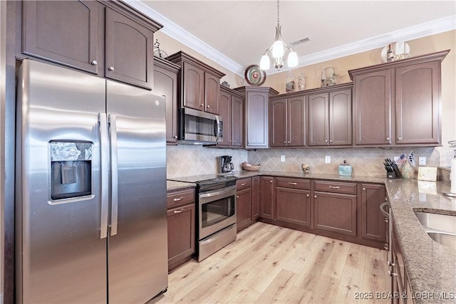 1184 Jeffries Rd Unit 113, Osage Beach, MO 65065 - kitchen with appliances with stainless steel finishes, ornamental molding, light stone countertops, light wood-style flooring, and dark brown cabinetry