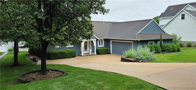 30141 Gentle Cv, Gravois Mills, MO 65037 - view of front of property with an attached garage, driveway, and a front lawn