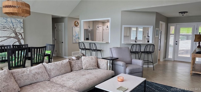30141 Gentle Cv, Gravois Mills, MO 65037 - living area featuring tile patterned flooring and vaulted ceiling