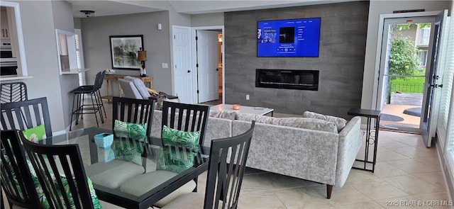 30141 Gentle Cv, Gravois Mills, MO 65037 - dining space featuring a large fireplace and light tile patterned floors