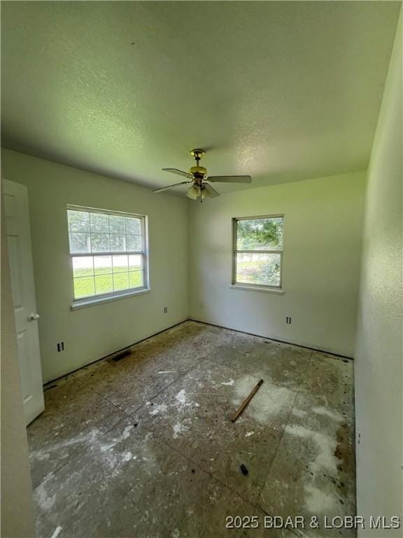 1509 Oak Bend Rd, Sunrise Beach, MO 65079 - unfurnished room with plenty of natural light and ceiling fan