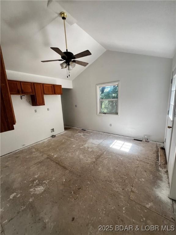 1509 Oak Bend Rd, Sunrise Beach, MO 65079 - unfurnished living room featuring a ceiling fan and vaulted ceiling