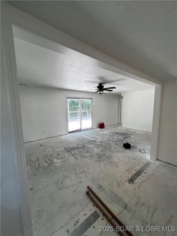 1509 Oak Bend Rd, Sunrise Beach, MO 65079 - unfurnished living room with a ceiling fan and a textured ceiling