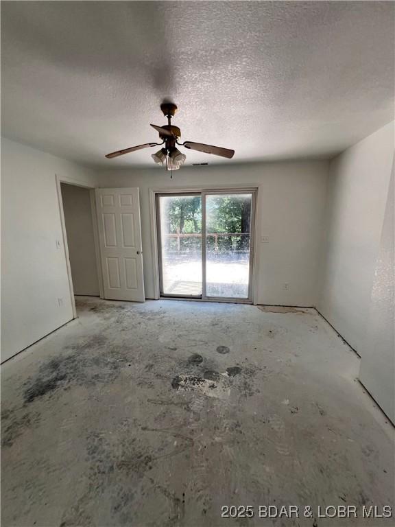 1509 Oak Bend Rd, Sunrise Beach, MO 65079 - spare room featuring a ceiling fan and a textured ceiling