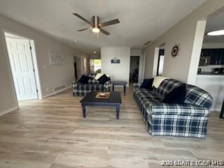 320 Regatta Bay Cir Unit 3B, Lake Ozark, MO 65049 - living room featuring a ceiling fan and wood finished floors