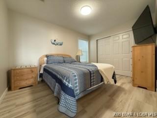 320 Regatta Bay Cir Unit 3B, Lake Ozark, MO 65049 - bedroom with wood finished floors and a closet