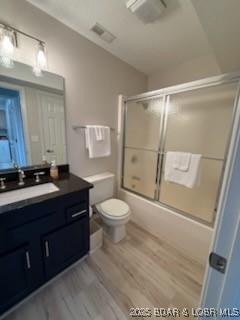 320 Regatta Bay Cir Unit 3B, Lake Ozark, MO 65049 - bathroom featuring vanity, wood finished floors, and shower / bath combination with glass door