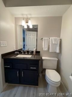 320 Regatta Bay Cir Unit 3B, Lake Ozark, MO 65049 - bathroom featuring a chandelier, vanity, and wood finished floors