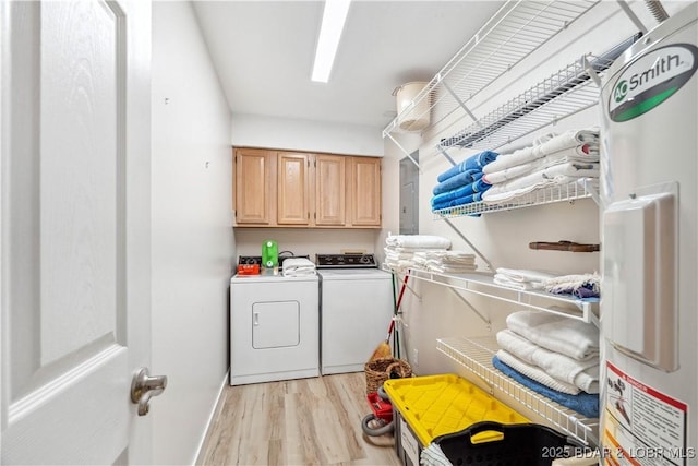 320 Regatta Bay Cir Unit 3B, Lake Ozark, MO 65049 - laundry room with cabinet space, strapped water heater, light wood-style floors, and washer and dryer