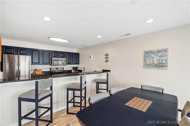 320 Regatta Bay Cir Unit 3B, Lake Ozark, MO 65049 - dining space featuring light wood finished floors and recessed lighting