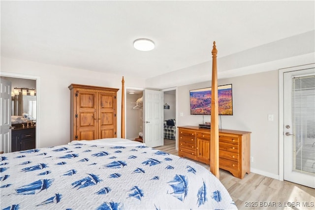 320 Regatta Bay Cir Unit 3B, Lake Ozark, MO 65049 - bedroom with light wood-style flooring, a closet, and ensuite bathroom