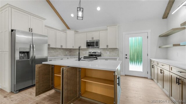 1778 Country Club Dr, Lake Ozark, MO 65049 - kitchen featuring open shelves, appliances with stainless steel finishes, tasteful backsplash, and light wood finished floors