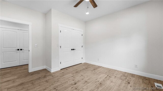1778 Country Club Dr, Lake Ozark, MO 65049 - unfurnished bedroom featuring wood finished floors and ceiling fan