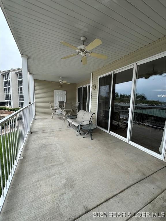 18134 Millstone Cove Rd Unit 212, Gravois Mills, MO 65037 - balcony with ceiling fan and outdoor dining space