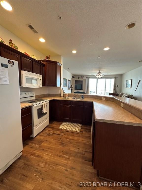 18134 Millstone Cove Rd Unit 212, Gravois Mills, MO 65037 - kitchen featuring white appliances, open floor plan, dark wood-style floors, recessed lighting, and a textured ceiling