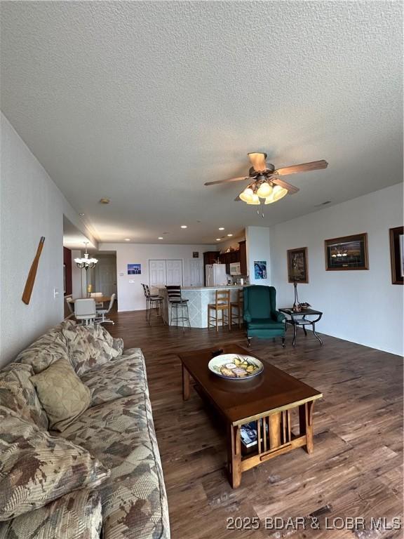 18134 Millstone Cove Rd Unit 212, Gravois Mills, MO 65037 - living area with wood finished floors, a chandelier, ceiling fan, and a textured ceiling