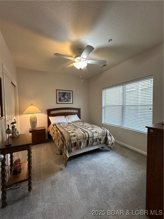 18134 Millstone Cove Rd Unit 212, Gravois Mills, MO 65037 - bedroom with carpet, a textured ceiling, and a ceiling fan
