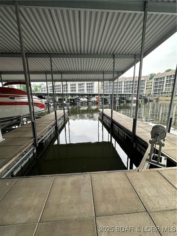 18134 Millstone Cove Rd Unit 212, Gravois Mills, MO 65037 - dock featuring a water view and boat lift