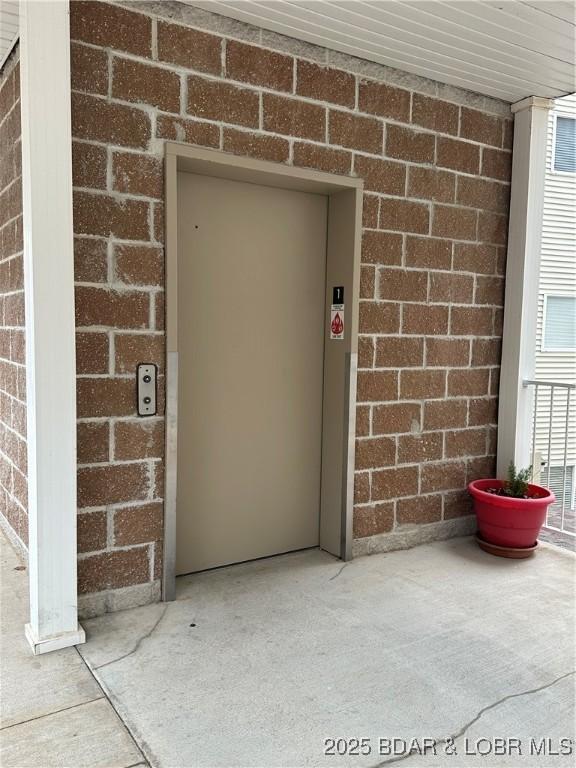18134 Millstone Cove Rd Unit 212, Gravois Mills, MO 65037 - doorway to property with elevator and brick siding