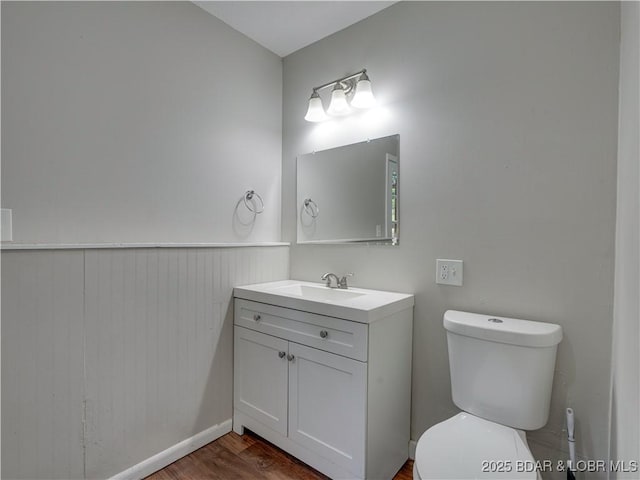 25 Primrose Ln, Camdenton, MO 65020 - half bath featuring vanity, wood finished floors, wainscoting, and wooden walls