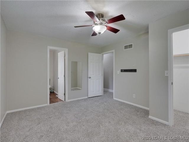 25 Primrose Ln, Camdenton, MO 65020 - unfurnished bedroom featuring carpet floors, a spacious closet, a textured ceiling, a closet, and ceiling fan