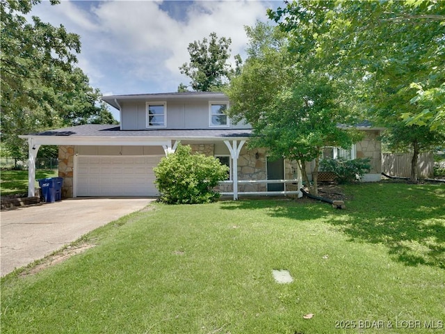 25 Primrose Ln, Camdenton, MO 65020 - view of front facade with stone siding, driveway, a front yard, and a garage