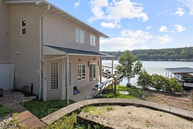 29773 Hemlock Rd, Gravois Mills, MO 65037 - view of home's exterior featuring a water view and stucco siding