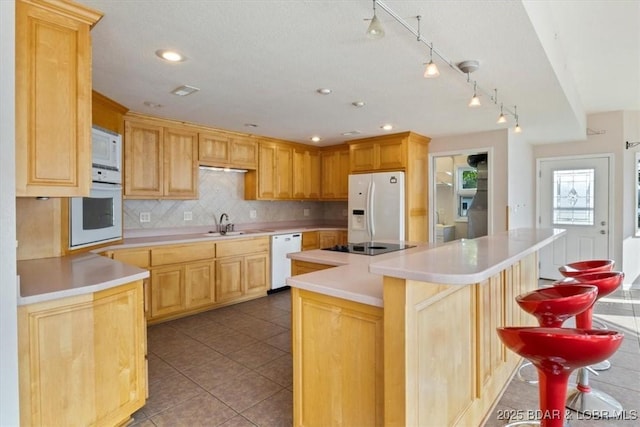 29773 Hemlock Rd, Gravois Mills, MO 65037 - kitchen with white appliances, a center island, backsplash, light countertops, and light brown cabinets
