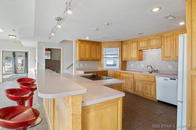 29773 Hemlock Rd, Gravois Mills, MO 65037 - kitchen featuring white appliances, light countertops, tasteful backsplash, a center island, and recessed lighting