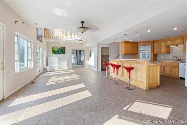 29773 Hemlock Rd, Gravois Mills, MO 65037 - kitchen featuring white appliances, light countertops, open floor plan, backsplash, and ceiling fan