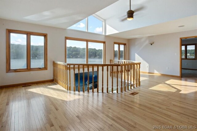 29773 Hemlock Rd, Gravois Mills, MO 65037 - spare room with wood-type flooring, plenty of natural light, a ceiling fan, and a water view