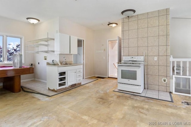 29773 Hemlock Rd, Gravois Mills, MO 65037 - kitchen featuring white range with gas cooktop, white cabinets, tile walls, concrete floors, and light countertops