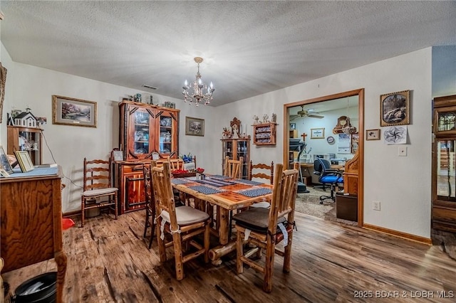 2936 State Road Y Rd, Linn Creek, MO 65052 - dining space with wood finished floors, a chandelier, an office area, a ceiling fan, and a textured ceiling