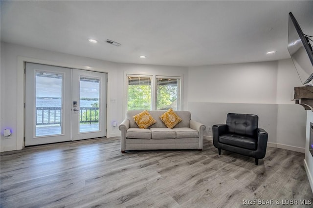 172 Kansas City Way, Sunrise Beach, MO 65079 - living room featuring french doors, wood finished floors, and recessed lighting