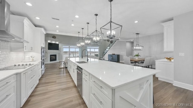 5450 Christopher Dr Unit 243, Osage Beach, MO 65065 - kitchen featuring wall chimney exhaust hood, appliances with stainless steel finishes, a large island, white cabinets, and recessed lighting