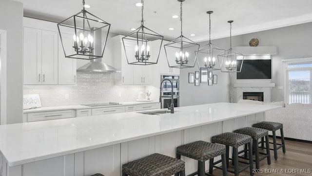 5450 Christopher Dr Unit 243, Osage Beach, MO 65065 - kitchen with a chandelier, black electric stovetop, double oven, tasteful backsplash, and recessed lighting