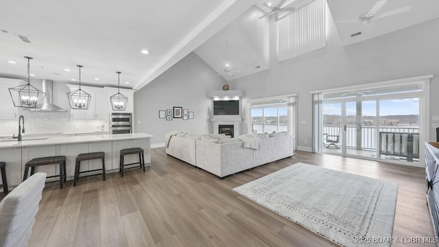 5450 Christopher Dr Unit 243, Osage Beach, MO 65065 - living area with a ceiling fan, a fireplace, high vaulted ceiling, recessed lighting, and wood finished floors