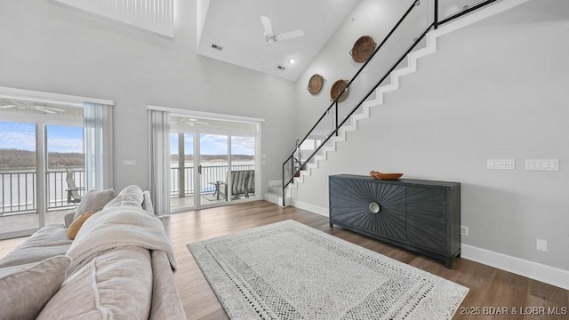 5450 Christopher Dr Unit 243, Osage Beach, MO 65065 - living room with stairway, plenty of natural light, a towering ceiling, wood finished floors, and ceiling fan
